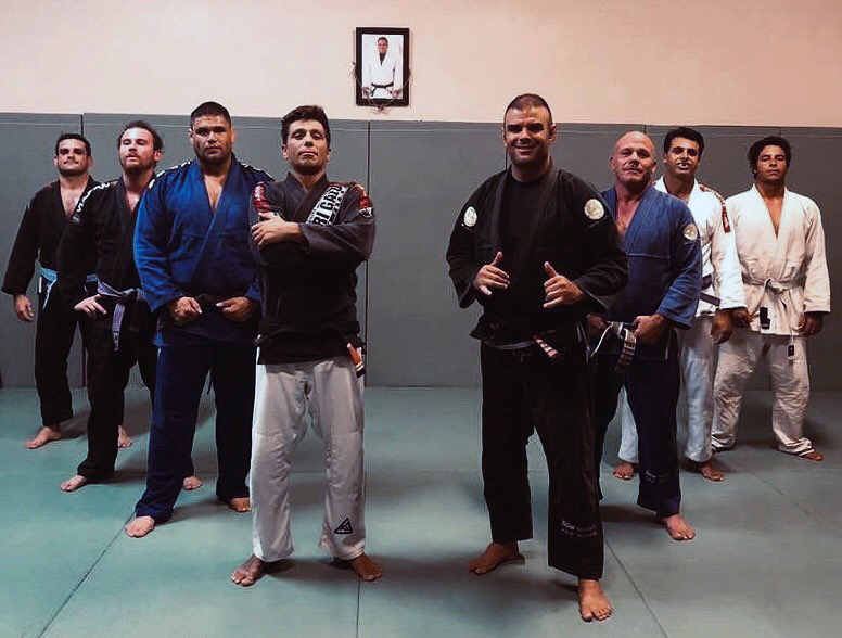 Adult students in gis on the mats at the academy